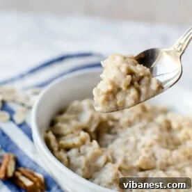 spoon of oatmeal pulling out of a bowl of oatmeal.