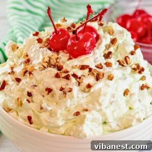 bowl of creamy Watergate salad made with pistachio pudding, pineapple, mini marshmallow and chopped pecans.