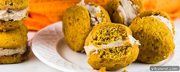 Delicious pumpkin whoopie pies with a generous swirl of cinnamon cream cheese frosting, perfect for fall