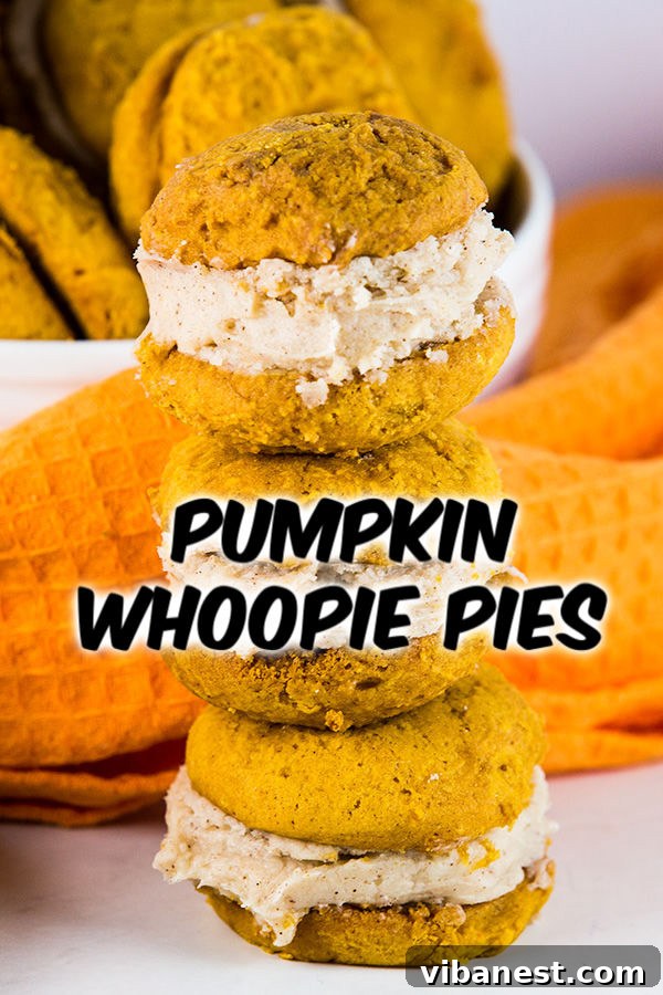 Close-up of a stack of pumpkin whoopie pies, showing the soft cookie texture and creamy filling