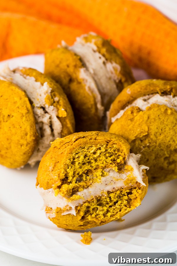 Scoops of pumpkin whoopie pie dough on an ungreased baking sheet, ready for the oven