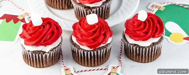Elf on the Shelf themed cupcakes with red frosting and mini marshmallows, perfect for a holiday treat