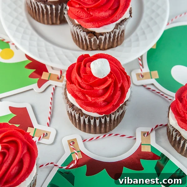 A finished Elf on the Shelf cupcake presented on a festive holiday plate, ready to be enjoyed.
