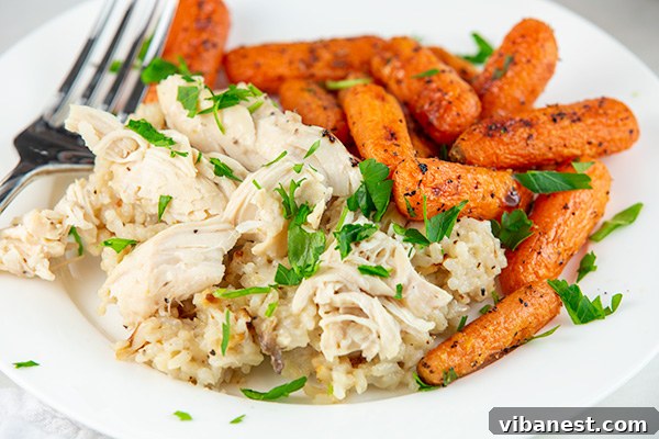 instant-pot-chicken-rice-3.jpg A close-up of chicken and rice cooking in an Instant Pot, showing the creamy texture.