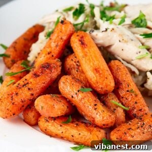 Oven Roasted Baby Carrots on a plate, garnished with fresh parsley.