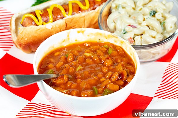 Serving of baked beans with corn on the cob