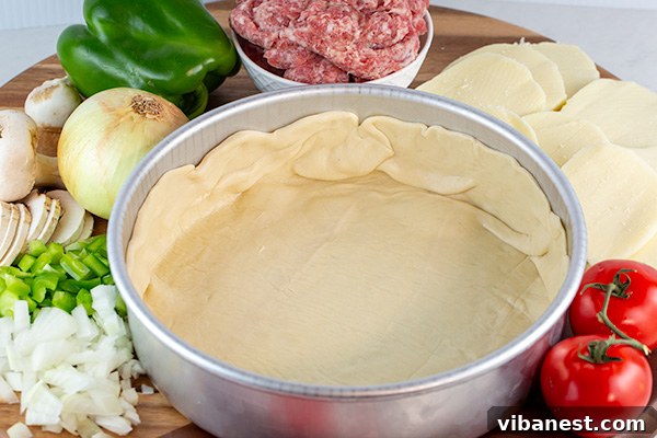 Pizza dough pressed into a deep-dish pan, forming a bowl