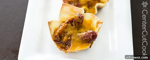 Golden brown cheesy little smokie cups, freshly baked and arranged on a platter, ready for serving at a party