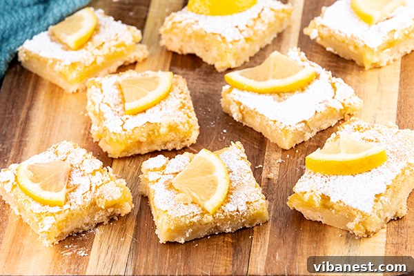 lemon-bars-3.jpg Plated easy lemon bars with powdered sugar and lemon wedges.