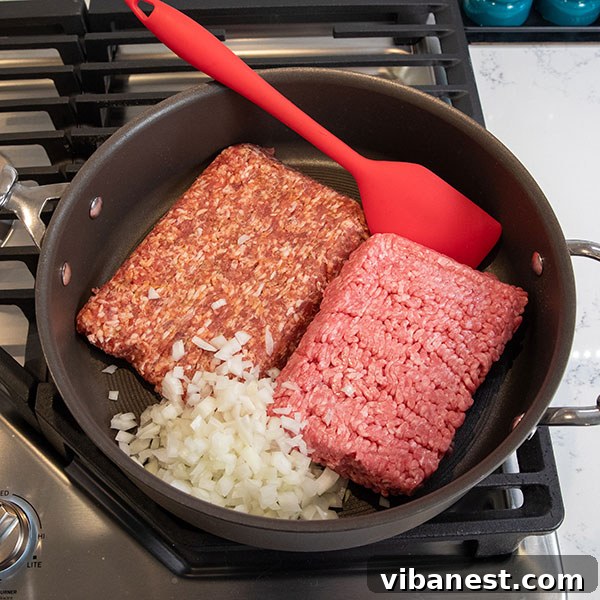 Cooking Meat for Pizza Casserole Ground meat and onions cooking in a skillet for pizza casserole