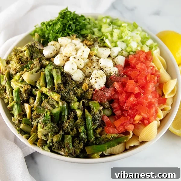 roasted-vegetable-pasta-salad-9.jpg A serving of roasted vegetable pasta salad on a plate