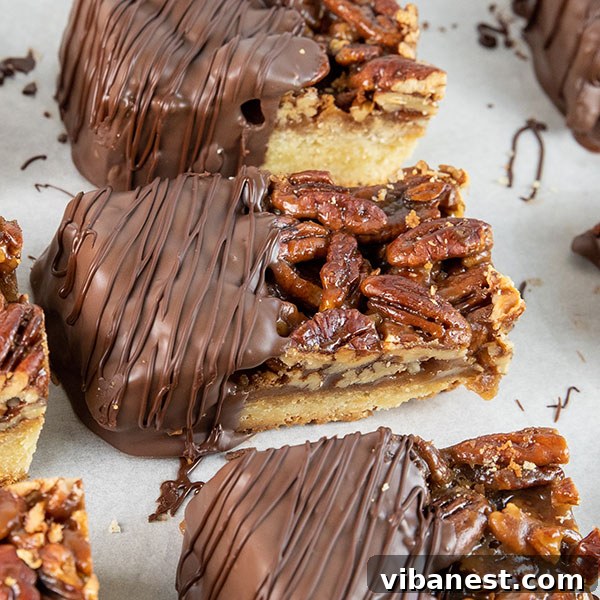 Stacked-Pecan-Pie-Bars-Close-Up.jpg Several chocolate dipped pecan pie bars neatly stacked, ready to be enjoyed