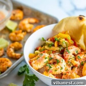 Sweet Heat Air Fryer Shrimp 10 air fryer shrimp tossed with creamy sweet chili sauce and garnished with chopped fresh cilantro in a white bowl.