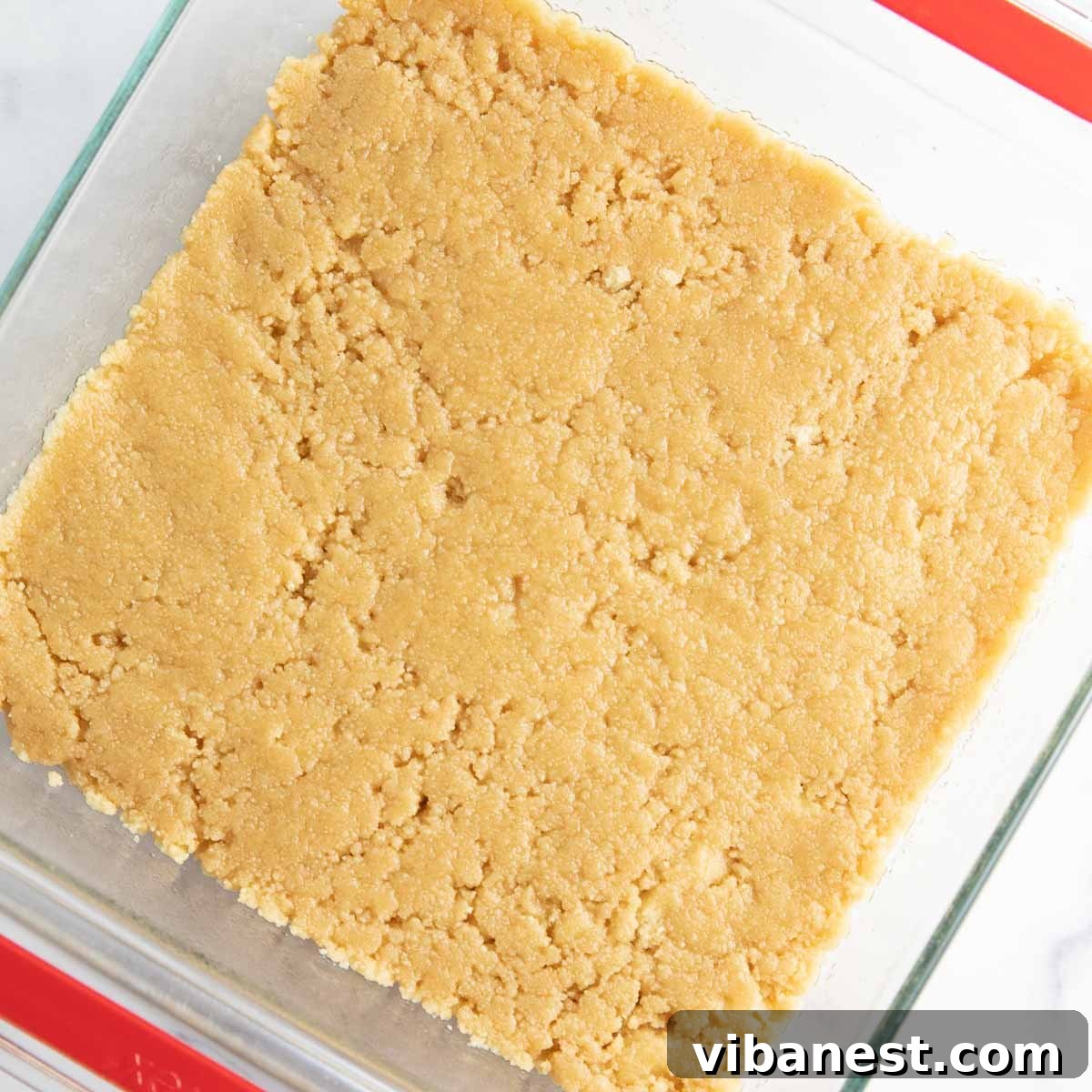 Strawberry Layered Delight 8 Combining cookie crumbs with butter to make the shortbread cookie crust.