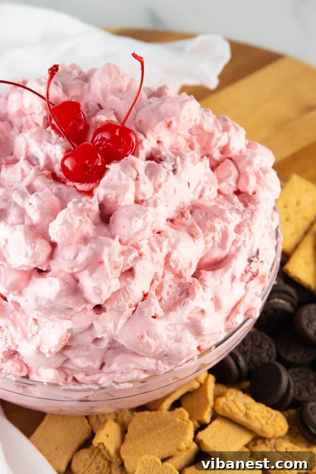 easy-cherry-fluff-salad-5.jpg A bowl of cherry fluff recipe, showing its pink color and fluffy texture.