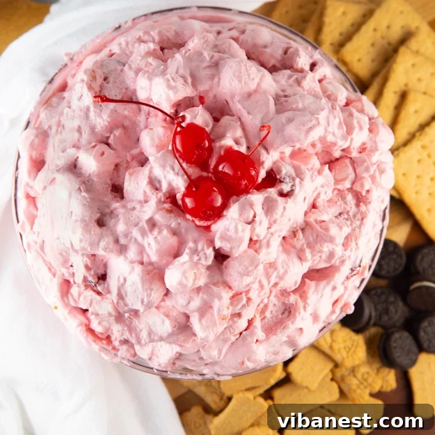 easy-cherry-fluff-salad-3.jpg Cherry Pie Filling Salad scooped into a serving bowl.
