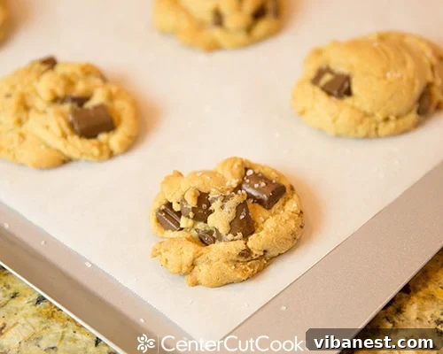 Sprinkling sea salt on warm cookies Close-up of freshly baked cookies being sprinkled with sea salt