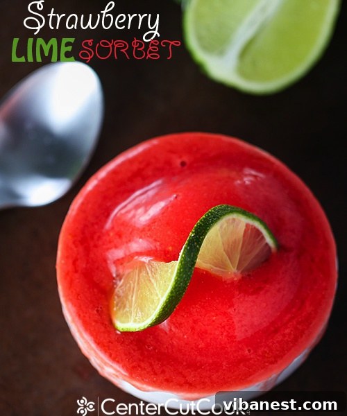 Essential Ingredients for Strawberry Lime Sorbet Arrangement of fresh and frozen ingredients for strawberry lime sorbet: a bowl of frozen strawberries, a whole lime, a small bowl of sugar, and a glass of water, all ready for blending