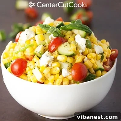 Serving bowl of Fresh Corn Salad with a spoon