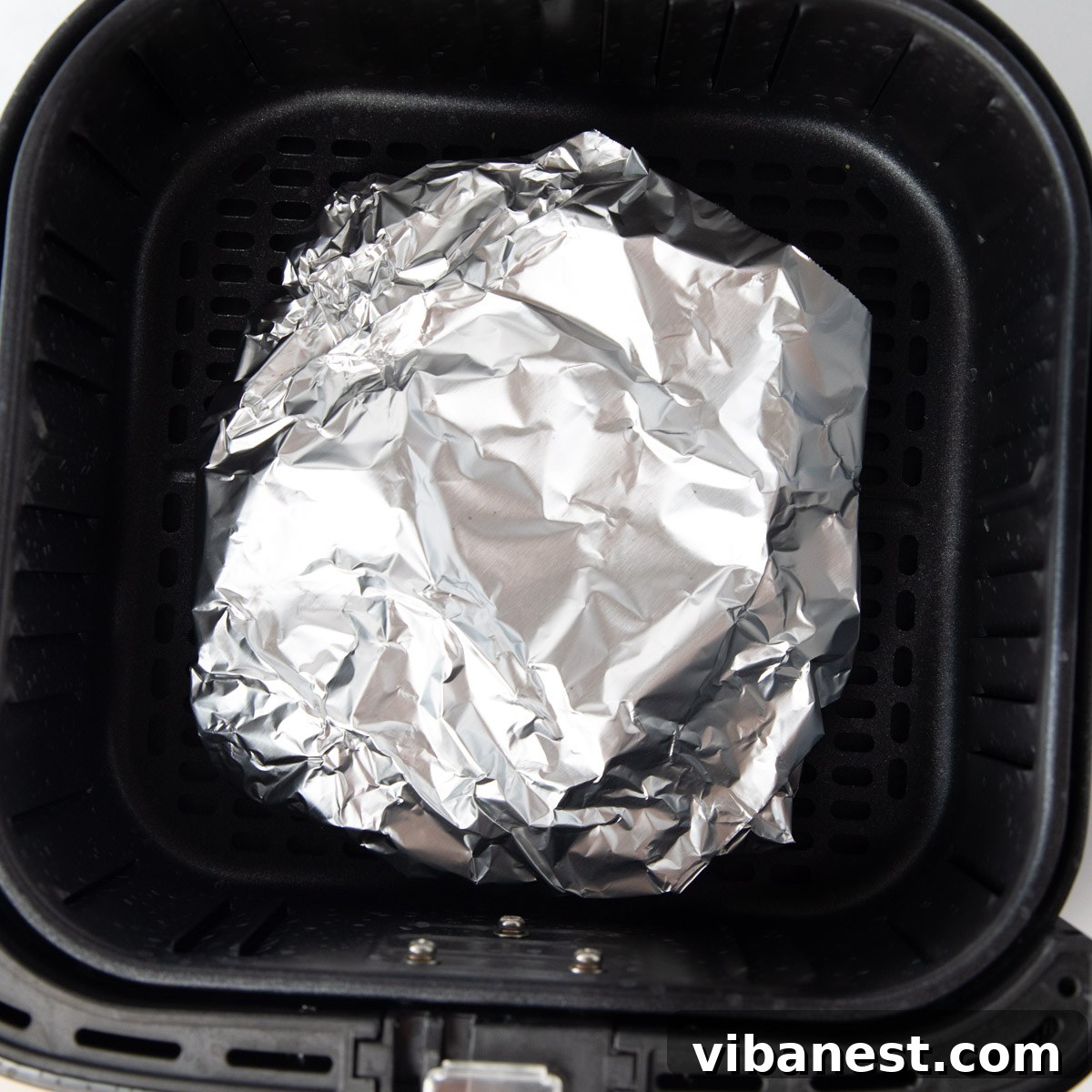 Air Fryer Taco Shells Perfectly Crispy 4 taco shells wrapped in foil in air fryer