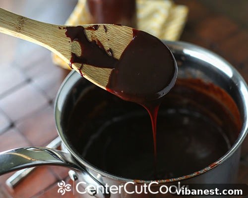 Hot Fudge Ingredients Close-up of the simple, high-quality ingredients for homemade hot fudge laid out: cream, sugar, cocoa powder, bittersweet chocolate chips, butter, and vanilla extract