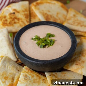 Taco Bell quesadilla sauce in a bowl surrounded by quesadillas
