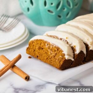 pumpkin bread with cream cheese frosting on a plate