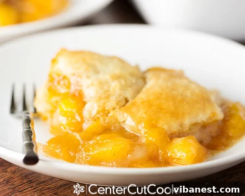 fresh peach cobbler 4.jpg Overhead view of a baking dish filled with fresh peach cobbler, ready to be served.