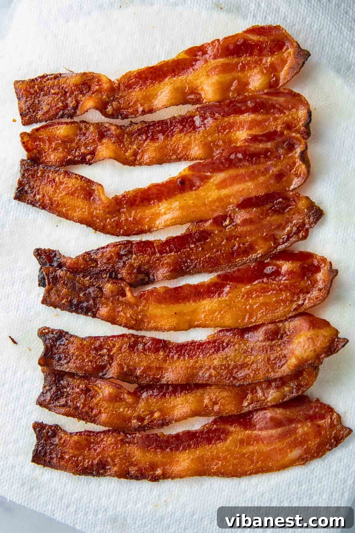 Crispy Oven Bacon Every Time 8 Plate of perfectly cooked crispy bacon, ready to be enjoyed.