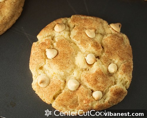 White Chocolate Chip Snickerdoodle Cookies on a cooling rack Close-up of freshly baked White Chocolate Chip Snickerdoodle Cookies, showing soft centers and melted white chocolate