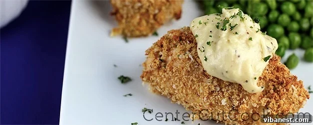 chicken cordon bleu rollups.jpg Two halves of a Chicken Cordon Bleu Rollup, showing the ham and melted cheese inside, served with sauce and fresh parsley.