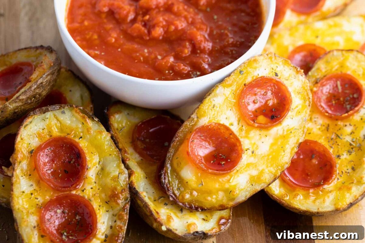Cheesy Pizza Potato Bites 13 An inviting overhead view of a platter piled high with expertly prepared pizza potato skins, steam gently rising, promising a warm and satisfying appetizer.