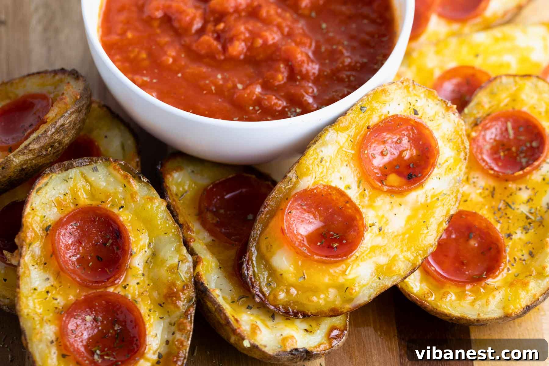 Cheesy Pizza Potato Bites 14 A grand, eye-level shot of a beautifully presented platter of crispy pizza potato skins, each generously loaded and perfectly golden, creating an enticing culinary display.