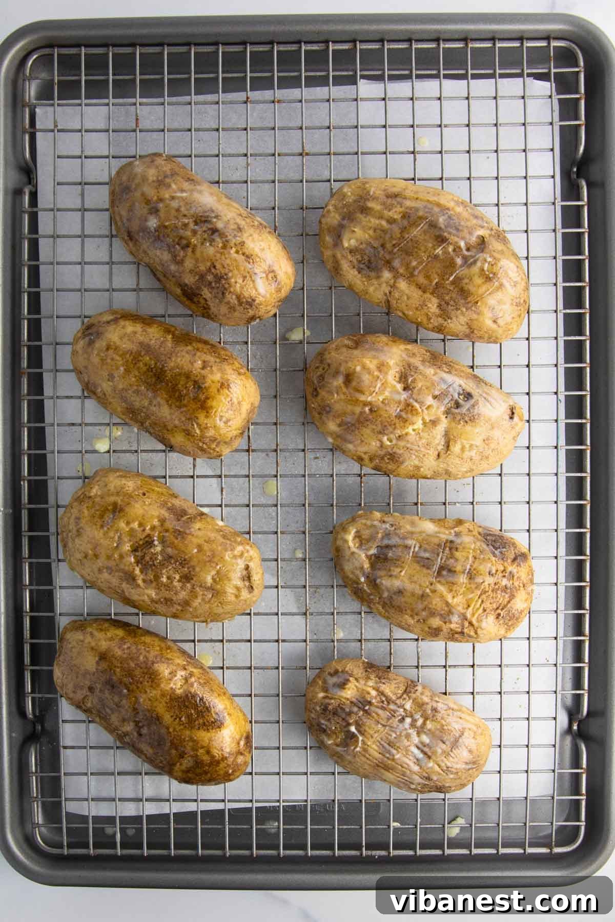Cheesy Pizza Potato Bites 8 A baking tray filled with russet potato halves, freshly baked and prepared, ready to be transformed into crispy potato skins.