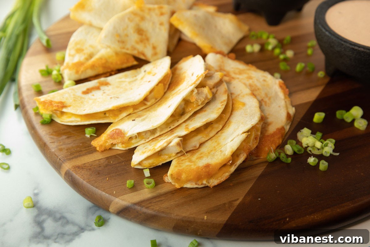 Whip Up Perfect Stovetop Quesadillas 2 Two golden-brown quesadillas served on a wooden board with a bowl of creamy queso and fresh salsa, garnished with cilantro, ready to be enjoyed.