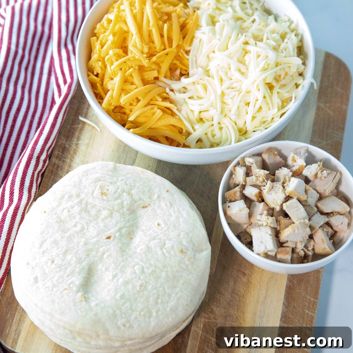 Whip Up Perfect Stovetop Quesadillas 3 Key ingredients for making quesadillas on the stove, including flour tortillas, shredded cheese, and a non-stick cooking spray.
