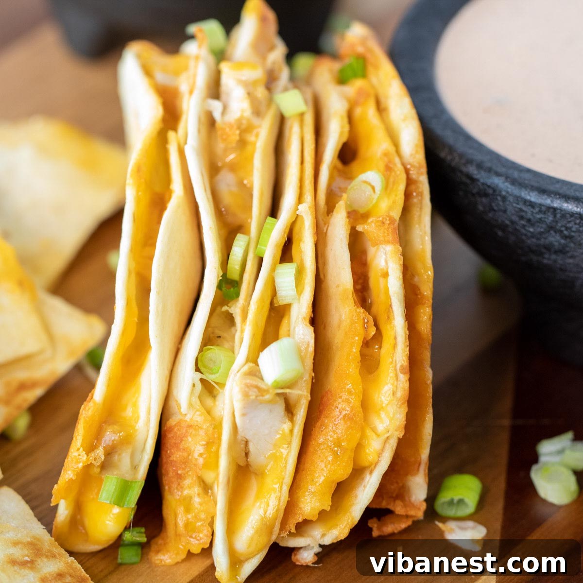 Whip Up Perfect Stovetop Quesadillas 5 Stack of four beautifully cooked quesadillas, perfectly golden and crispy, arranged neatly on a cutting board.