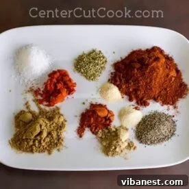 A plate of homemade taco seasoning ingredients including various spices, ready to be mixed.