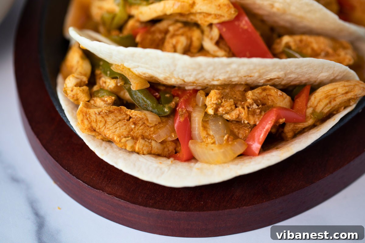 Speedy Instant Pot Chicken Fajitas 7 A plate of Instant Pot chicken fajitas, garnished with fresh cilantro and lime, ready to eat