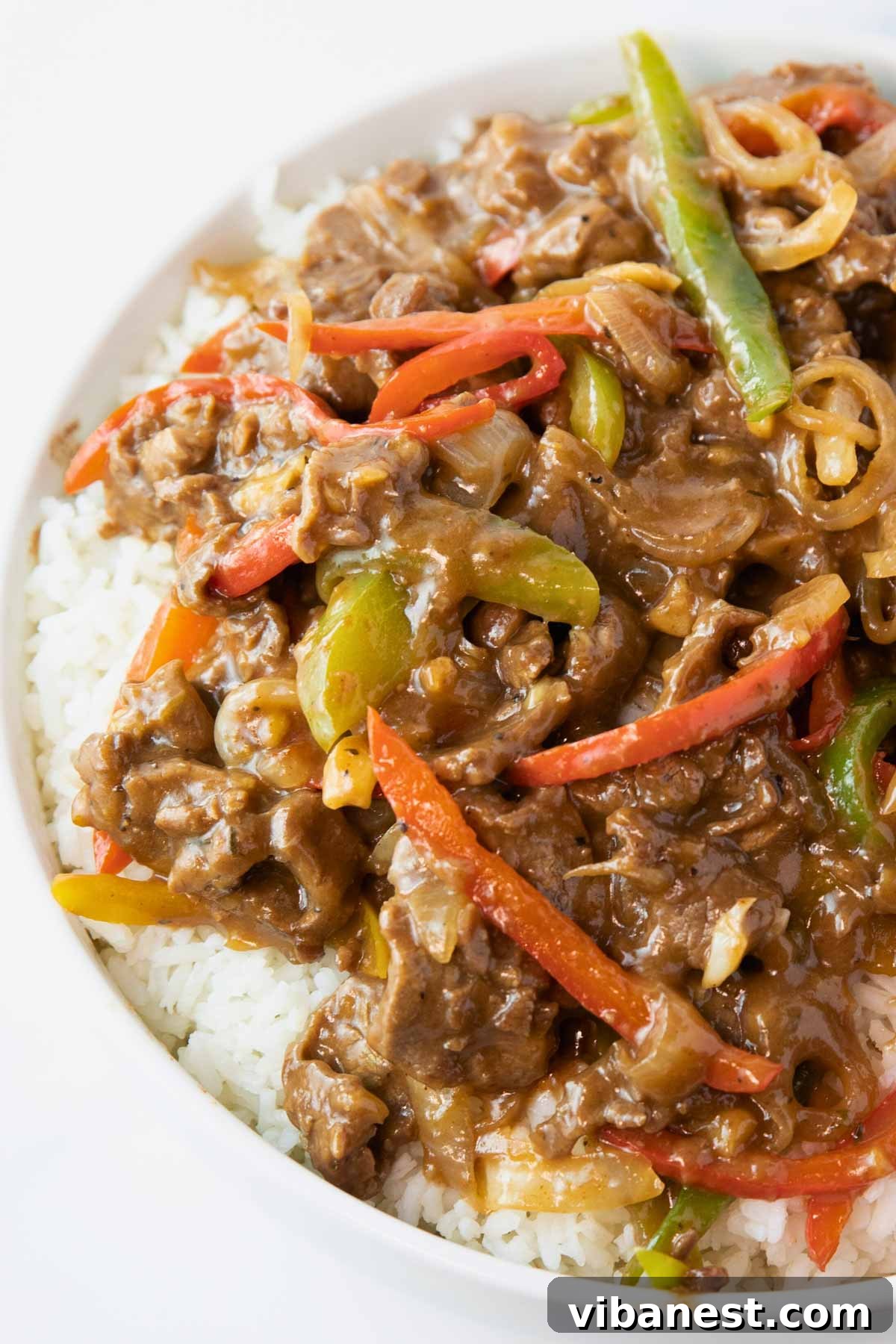 Sizzling Pepper Steak with Onions 8 Plate of pepper steak and onions over rice, showing tender sliced beef