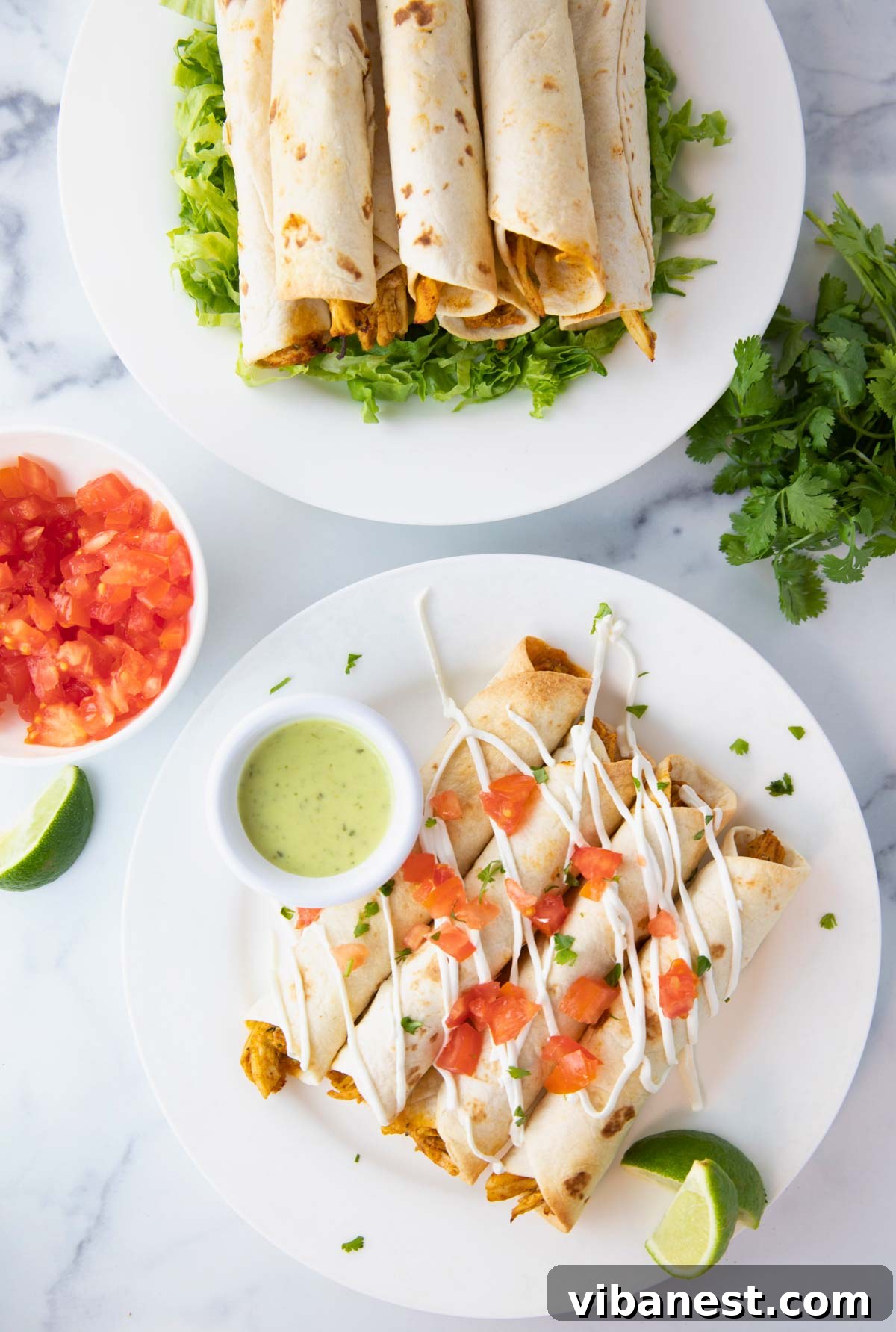 Crispy Air Fryer Chicken Taquitos 5 Overhead view of air fryer taquitos served on a rustic plate with various dipping sauces like guacamole and salsa, fresh lime wedges, and cilantro