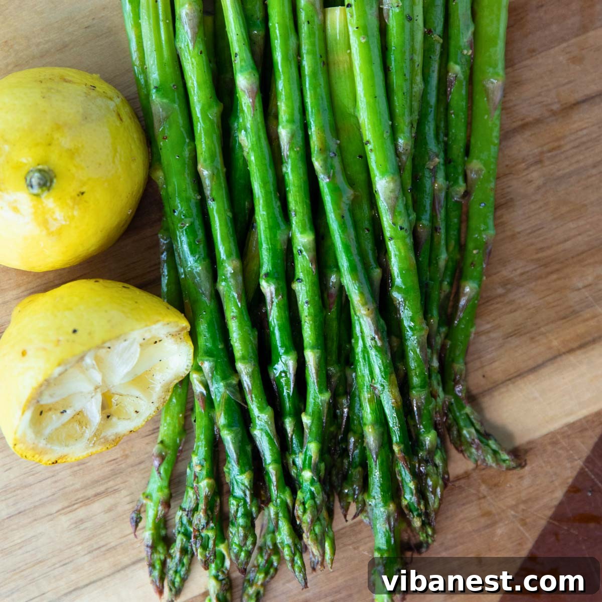 Effortless Grilled Asparagus 5 Perfectly grilled asparagus spears served with fresh lemon wedges, ready to be enjoyed.