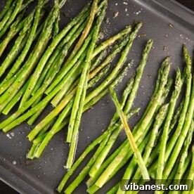 Oven roasted asparagus on a baking sheet, golden and tender.