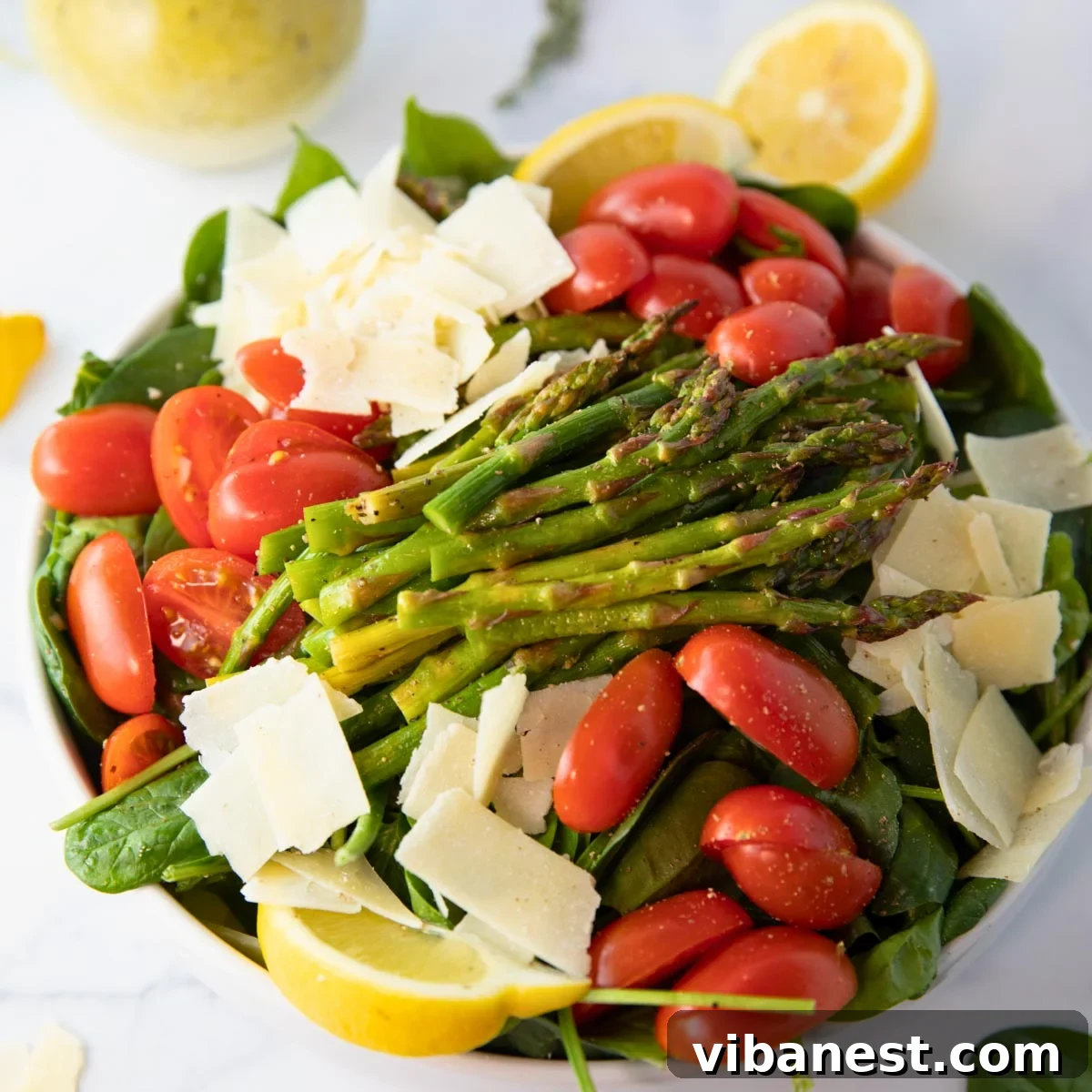 Smoky Grilled Asparagus Salad 2 A vibrant and fresh grilled asparagus salad with cherry tomatoes, parmesan, and mixed greens, ready to be served.