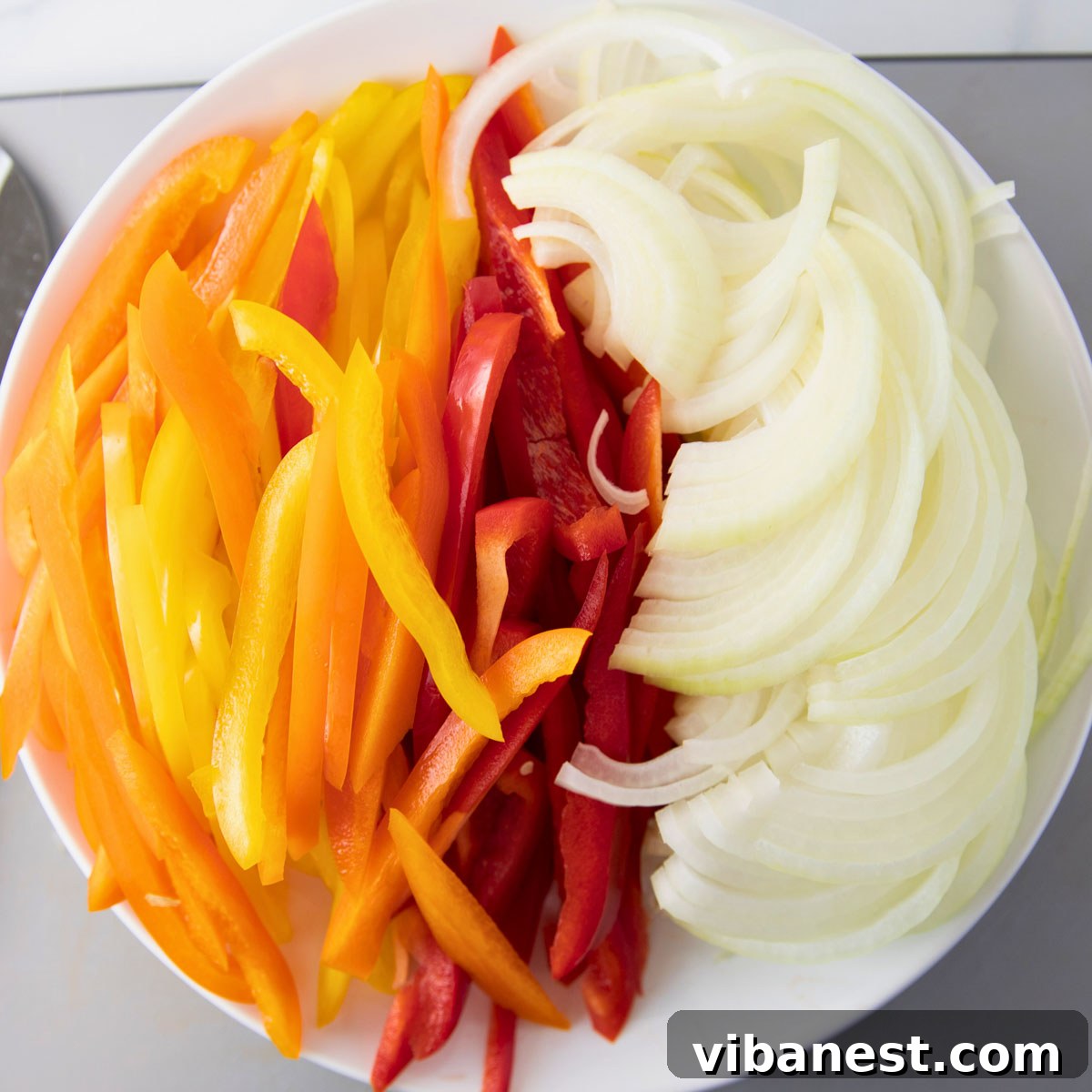 Sizzling Fajita Vegetables 4 overhead of bowl of sliced peppers and onion to make fajita veggies