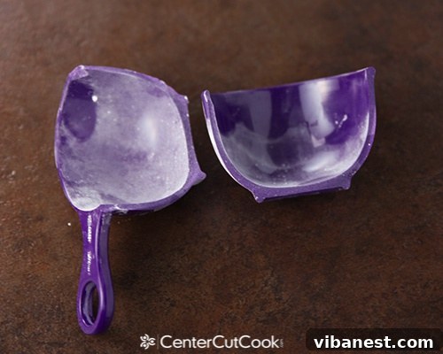 KitchenAid mishap with a measuring cup The author's purple measuring cup, split in half by a KitchenAid mixer