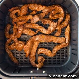 Beautifully cooked air fryer steak for fajitas and burritos, garnished and ready to be served.
