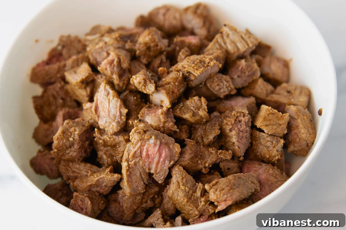Air Fryer Fajita Burrito Steak 6 A beautifully presented bowl of air fryer steak, perfectly cooked and ready for assembly into burritos and fajitas.