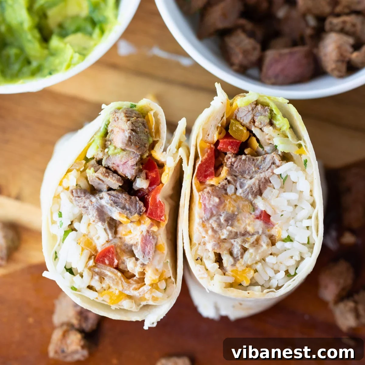 Simple Steak Burrito Delight 12 Another appealing overhead view of an easy steak burrito, accompanied by bowls of guacamole and sliced steak.