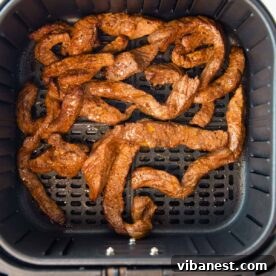 Air fryer steak for fajitas and burritos, showcasing tender, marinated steak slices.